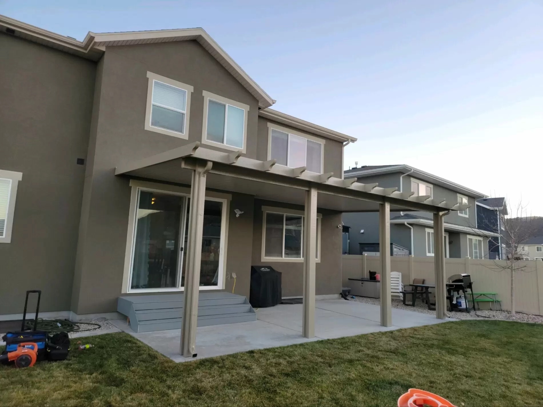 Covered Patio Tan Blue house with new siding